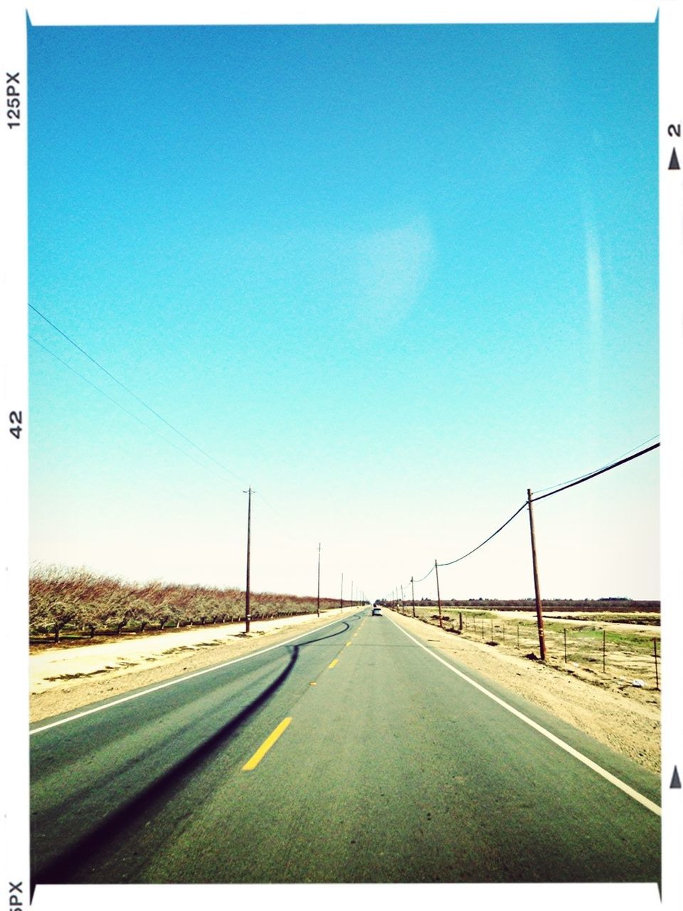 the way forward, transportation, road, diminishing perspective, vanishing point, road marking, transfer print, clear sky, blue, country road, empty road, long, empty, copy space, auto post production filter, sky, asphalt, highway, landscape, outdoors