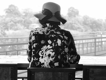 Rear view of woman sitting on seat