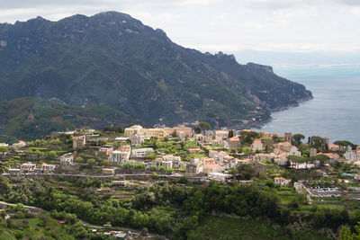 High angle view of townscape by sea against sky