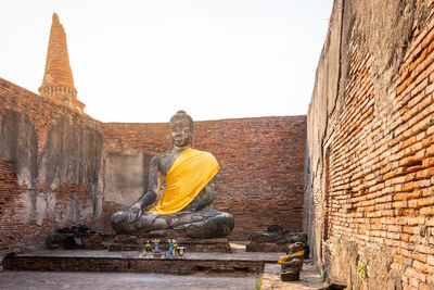 Statue of buddha against building