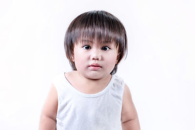 Portrait of cute boy against white background