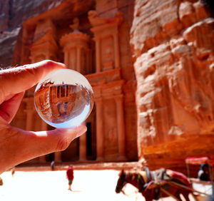 Person holding glass of building
