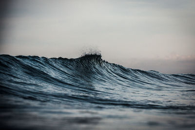 Close-up of waves in sea against sky