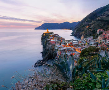 View of cityscape at seaside during sunset