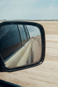 Reflection of car on side-view mirror