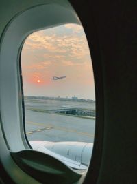 View of sunset through airplane window