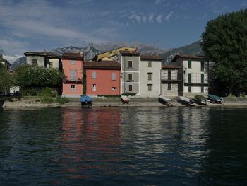 River by houses against sky