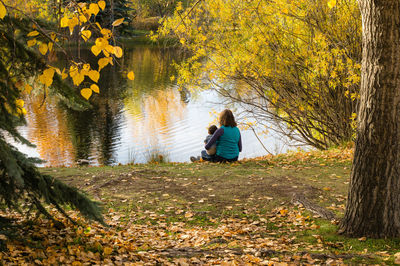 Rear view of man standing in lake