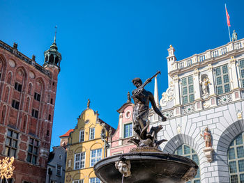 Neptune statue on the main street of old town, gdansk, poland. photo was taken 08.08.2020