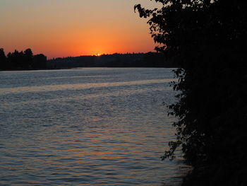 Scenic view of sea against orange sky