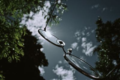 Close-up of glasses against sky