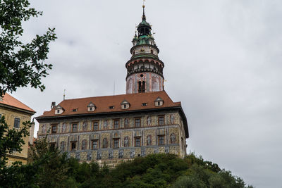 Low angle view of st jost church against cloudy sky in city