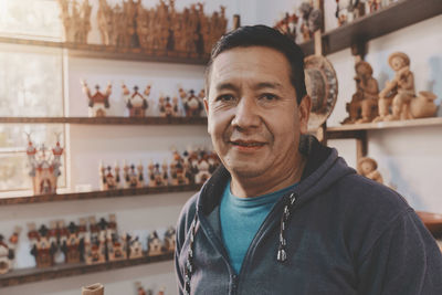 Portrait of young man standing in store