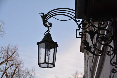 Low angle view of lamp on building against sky