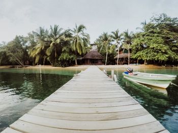 Scenic view of swimming pool by lake against sky