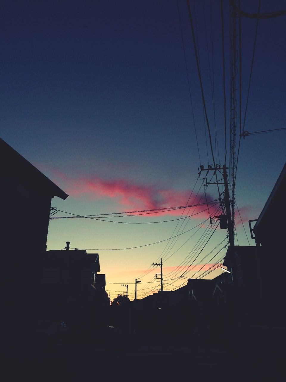 power line, electricity pylon, sunset, silhouette, building exterior, built structure, electricity, architecture, power supply, cable, low angle view, sky, connection, power cable, fuel and power generation, house, dusk, technology, blue, orange color