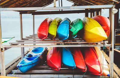 Multi colored shoes hanging on deck chairs at beach