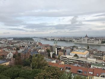 High angle shot of cityscape against cloudy sky