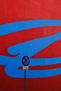 Low angle view of road sign against blue sky