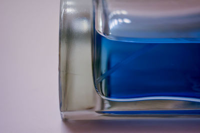 Close-up of glass against blue background