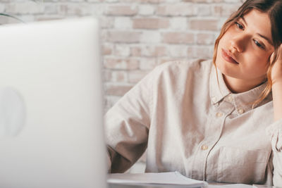 Young woman using laptop at home