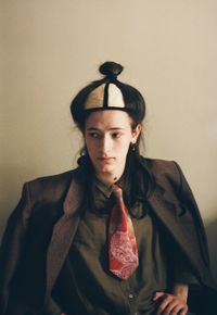 Portrait of young man standing against wall