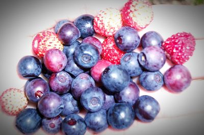 Close-up of red berries on white surface