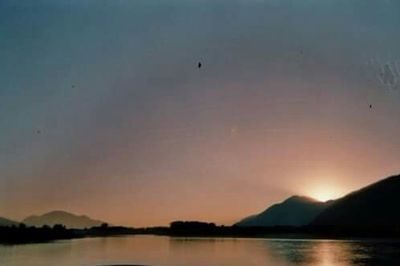 Scenic view of lake at sunset