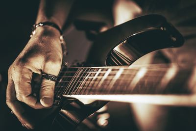 Cropped image of musician playing guitar