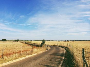 Country road passing through field