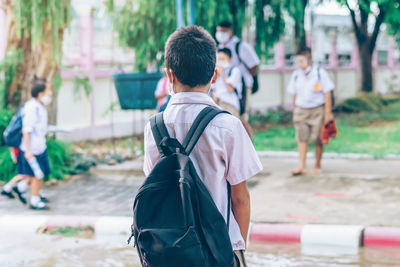 Rear view of people walking on street