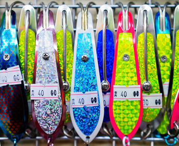 Close-up of multi colored clothes hanging for sale