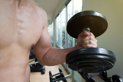 Close-up of shirtless man holding camera