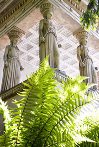 Low angle view of statue against historic building