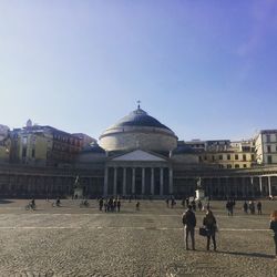 People at town square against clear sky