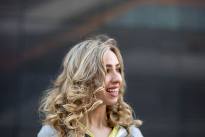 Smiling young woman looking away in city