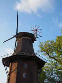 Low angle view of traditional windmill against sky