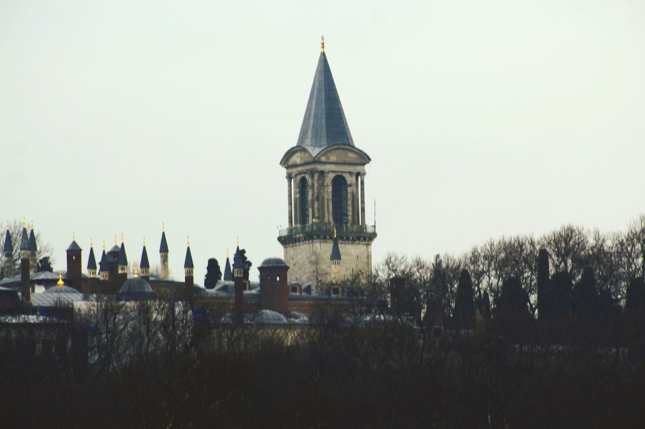 building exterior, built structure, architecture, sky, religion, building, clear sky, nature, spirituality, place of worship, belief, plant, tree, tower, no people, travel destinations, day, outdoors, spire, skyscraper, gothic style