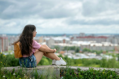 Rear view of woman looking at sea against sky