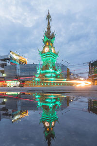Illuminated building in city at dusk
