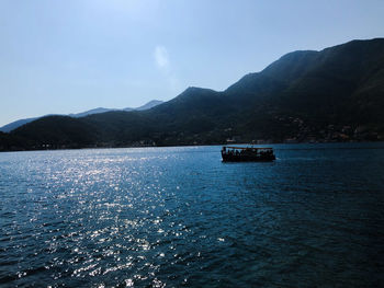 Scenic view of sea against mountain range