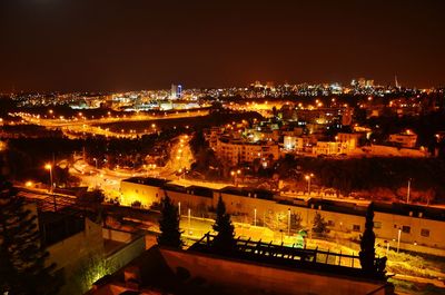 High angle view of illuminated buildings in city at night