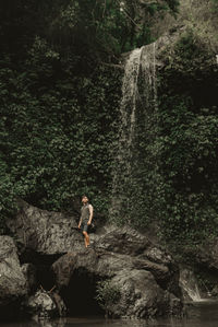 Rear view of man standing on rock