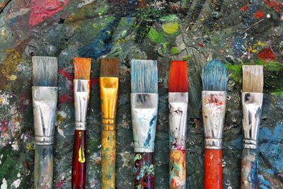 Close-up of paintbrushes on dirty table