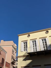 Low angle view of buildings against blue sky