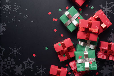 High angle view of christmas decorations on table against black background