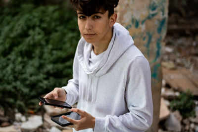 Portrait of young man using mobile phone