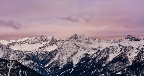 Scenic view of snowcapped mountains against sky during sunset