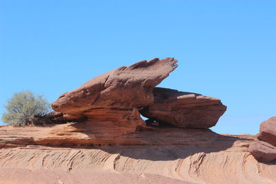 Rock formation against clear blue sky