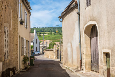 Street amidst buildings in city against sky